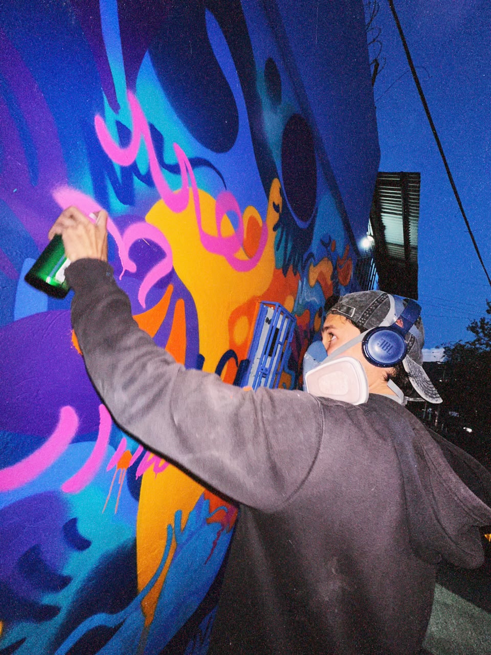 LUKO creating a colourful mural